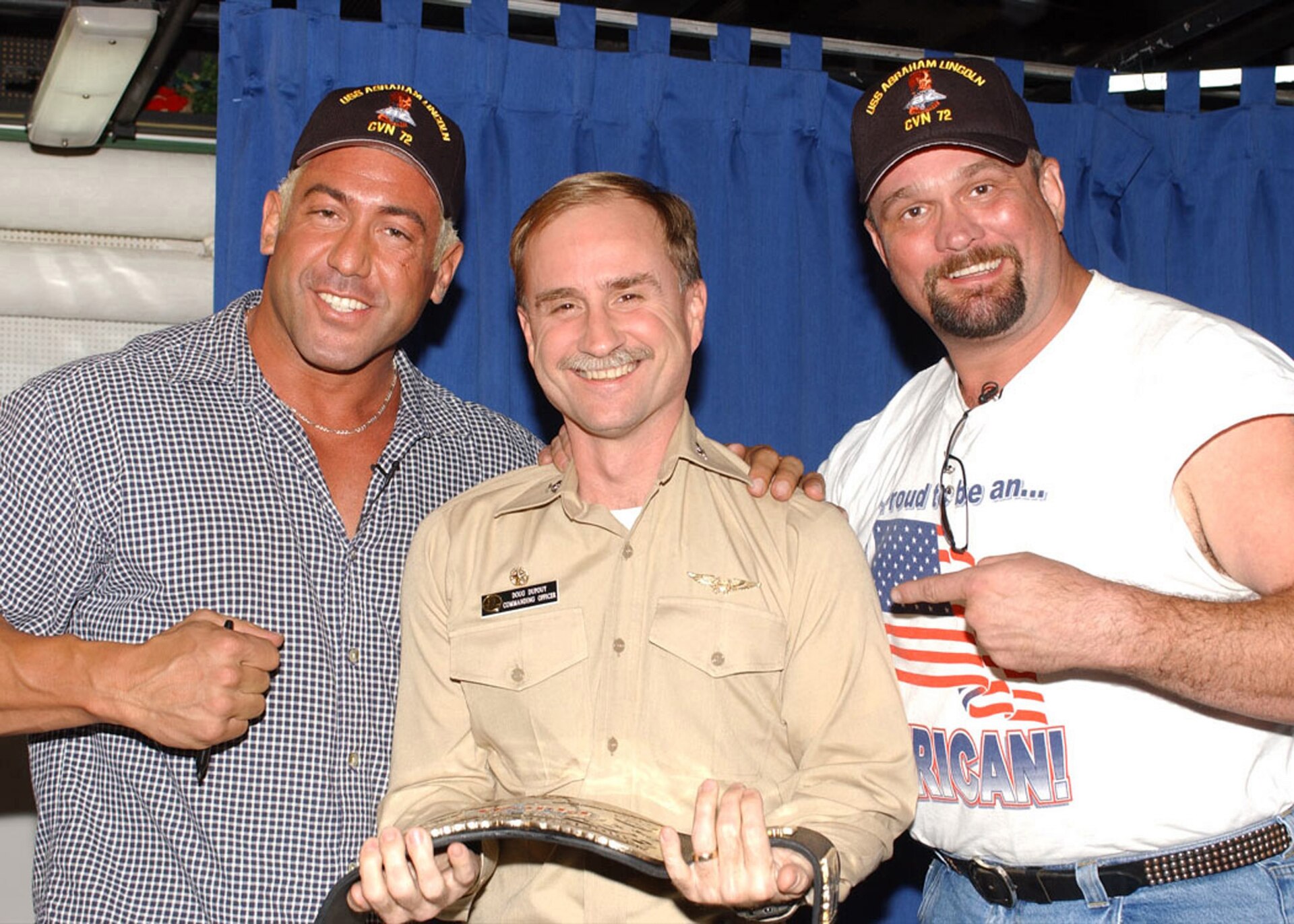 WWF Championship Belt being presented to USS Abraham Lincoln's commanding officer by WWF wrestlers Chuck Palumbo and The Big Boss Man in 2002